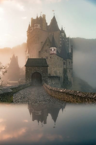 reflection of a castle surrounded with fogs